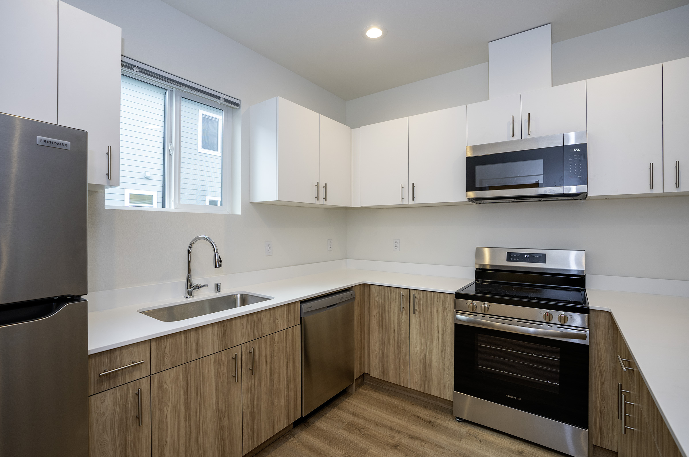 Lakewood Station kitchen with stainless steel appliances and quartz countertops